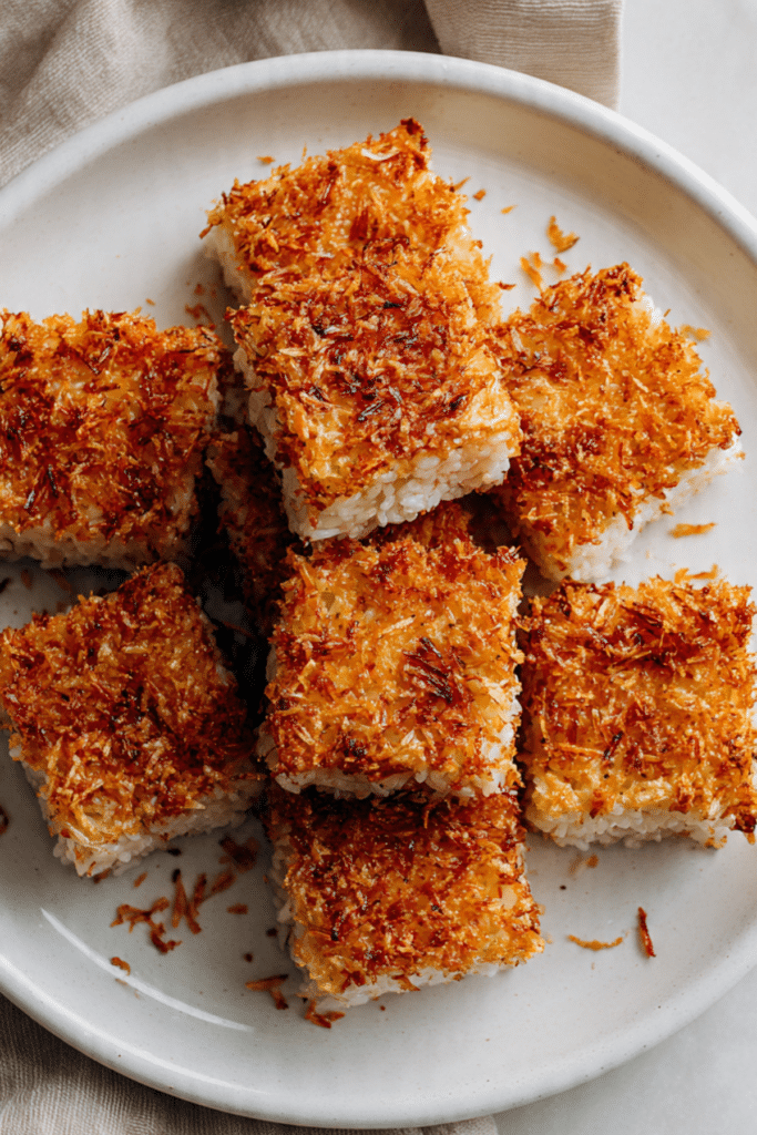 A top view, very zoomed out photo of a golden brown loaf of black sesame milk bread with a soft, fluffy interior speckled with black sesame seeds, placed at the center of a simple white table with soft natural shadows in the background. The loaf is whole with one thick slice cut and leaning slightly forward to reveal the airy crumb. Clean, minimal setting with no extra objects or scattered crumbs. photo taken with an iphone ar 2:3